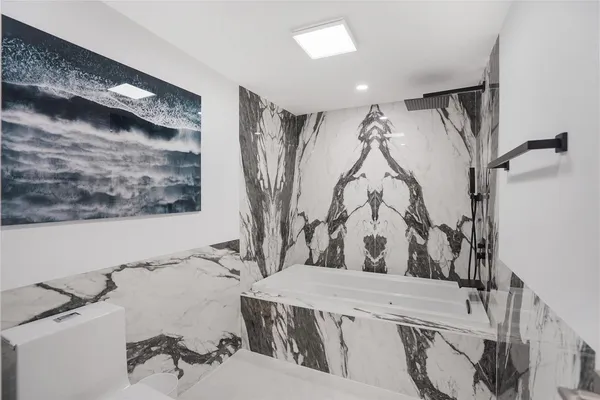 a view of walk in closet with clothes