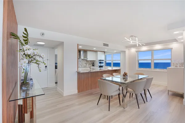 a dining room with furniture and wooden floor