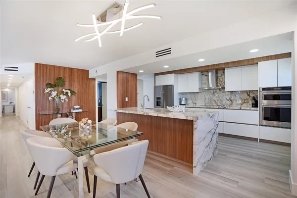 a view of kitchen with sink dining table and chairs