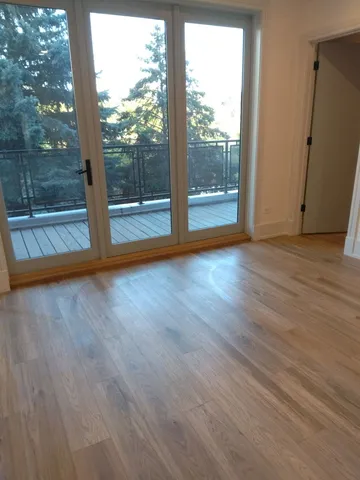 a view of room with wooden floor and window