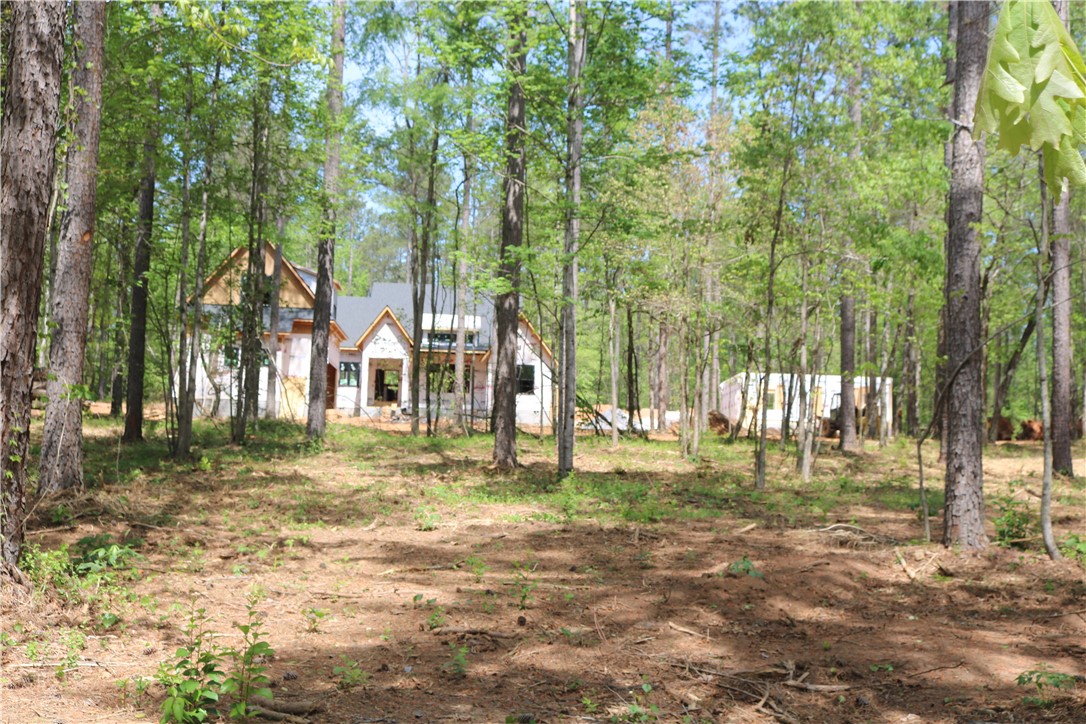 220 Mill Pine Road Liberty, SC 29657 - Photo 5 of 11 This new construction home is nestled in a private, wooded setting. The guest house can be seen to the right of the home.