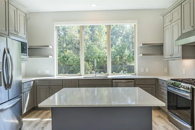 a kitchen with a stove a sink and a refrigerator