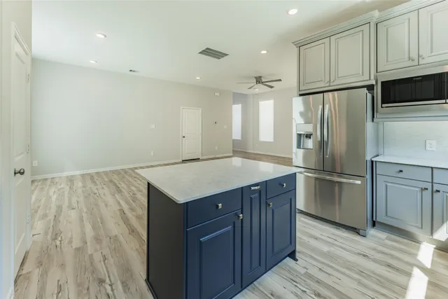 a kitchen with wooden cabinets and stainless steel appliances