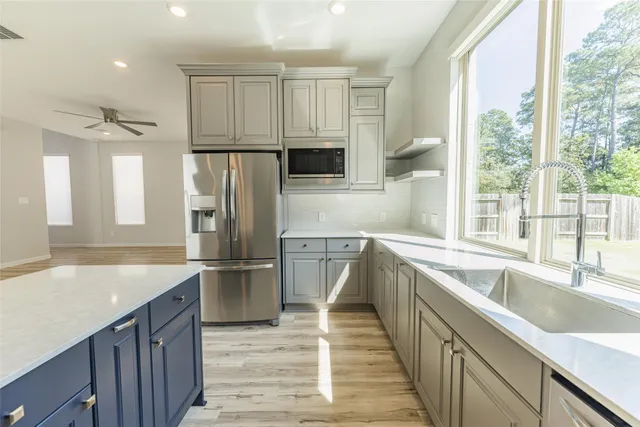 a kitchen with stainless steel appliances granite countertop a refrigerator and a sink