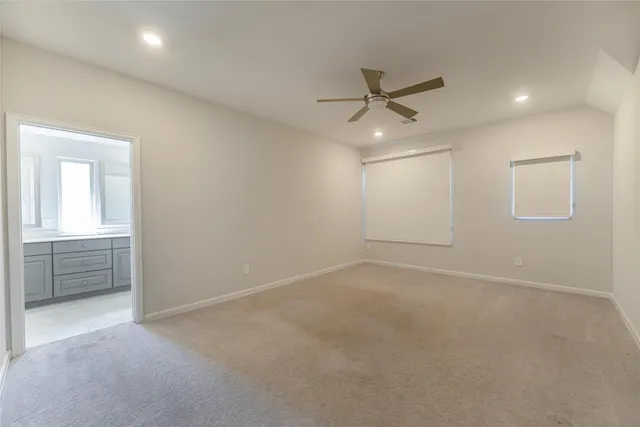 an empty room with closet and windows