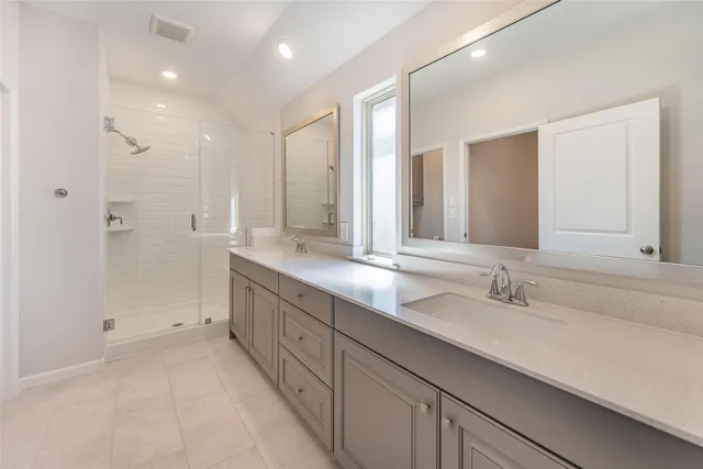 a bathroom with double sink and a mirror