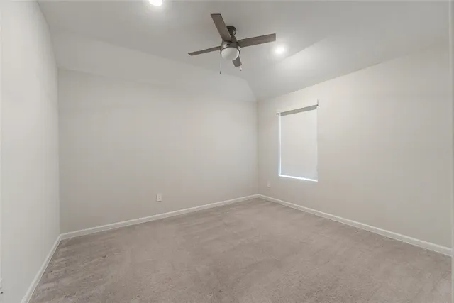 a view of a room with a ceiling fan and a window