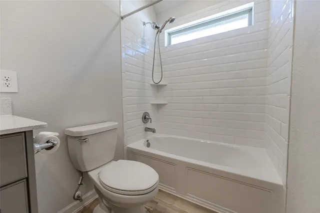 a white toilet sitting next to a bath tub