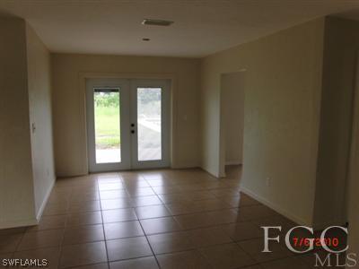 11750 Shawnee Road Fort Myers, FL 33913 - Photo 3 of 10 an empty room with windows and fan