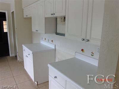 11750 Shawnee Road Fort Myers, FL 33913 - Photo 6 of 10 a utility room with cabinets washer and dryer