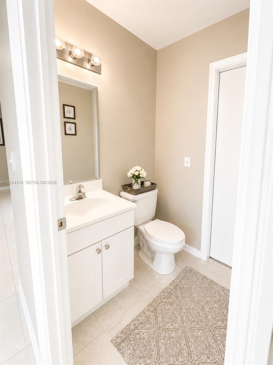 14856 Southwest 179th Street Miami, FL 33187 - Photo 29 of 33 a bathroom with a sink a toilet and mirror