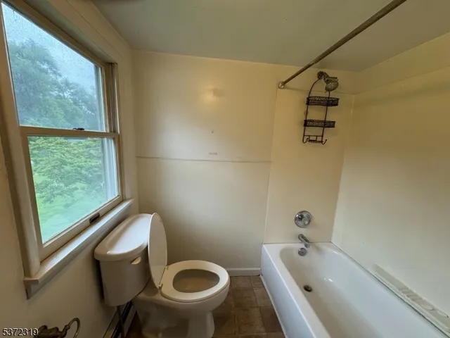 a bath tub sitting next to a toilet