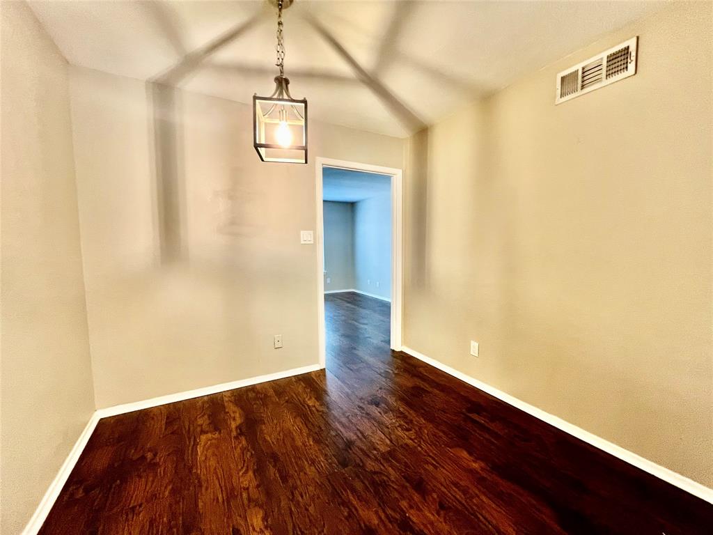 1107 North Locust Street, Unit 4 Denton, TX 76201 - Photo 5 of 8 Bright dining area with dark flooring and a view into the hallway.