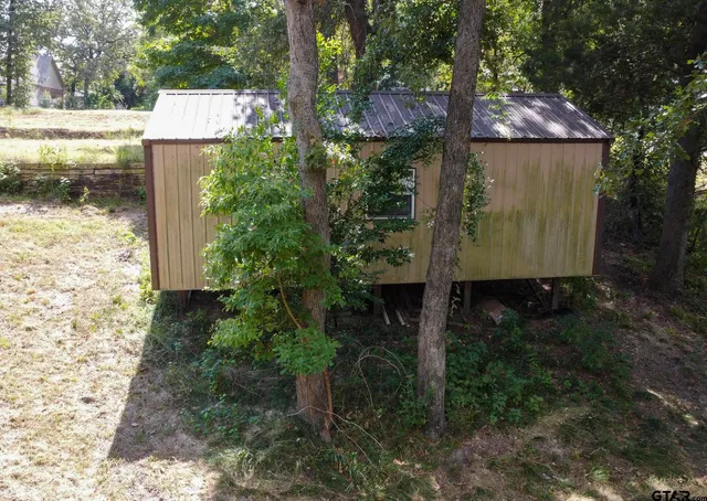 a view of a house with yard and sitting area