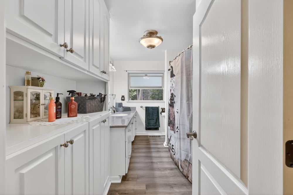 2026 Lily Valley Way West Point, CA 95255 - Photo 30 of 39 a hallway with cabinets and a painting