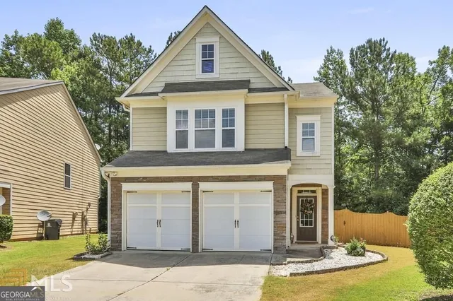 a front view of a house with garden