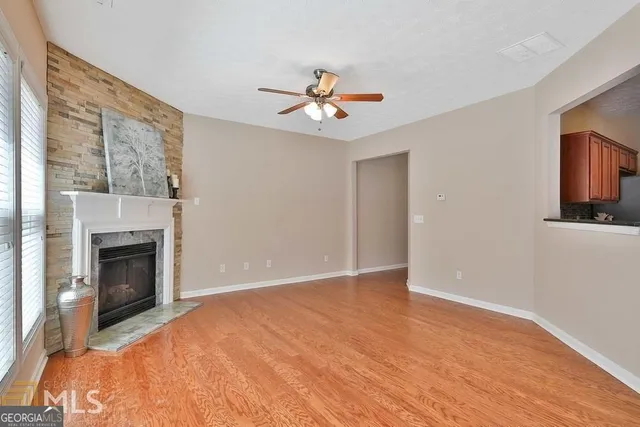 a view of empty room with fireplace and fan