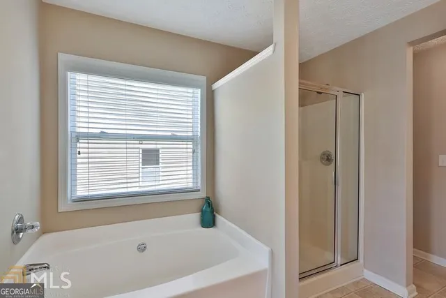 a bathroom with a bathtub and a shower