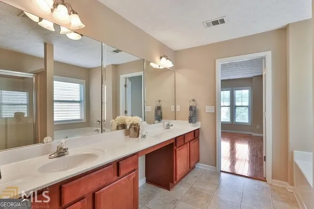 a bathroom with a sink double vanity and a mirror