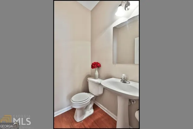 a bathroom with a sink toilet and a mirror