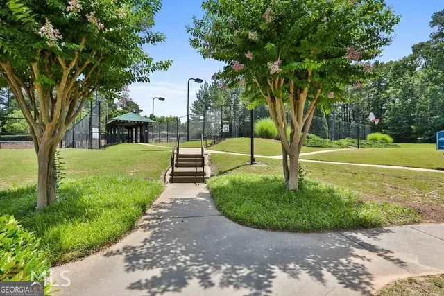 a view of a backyard with swimming pool