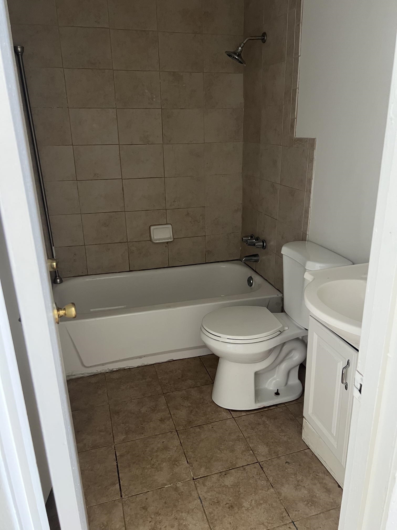 518 Harris Street Collierville, TN 38017 - Photo 10 of 13 Full bathroom featuring a white bathtub, ceramic tile surround, and a coordinating floor