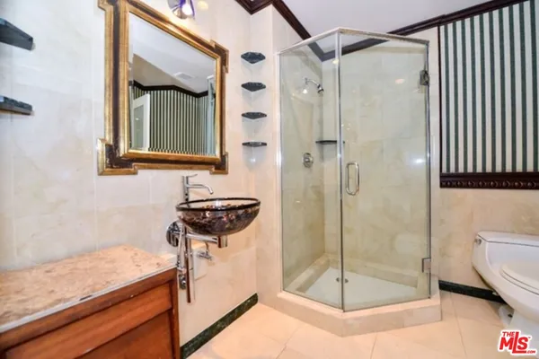 a bathroom with a shower and a sink