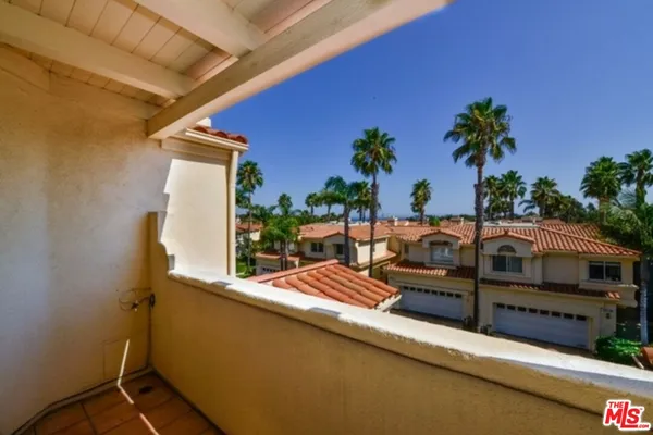 a view of a balcony with chairs