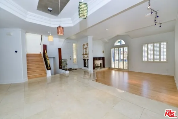 an empty room with fireplace and windows