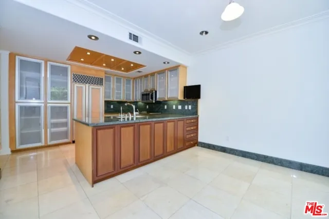 a kitchen with stainless steel appliances a sink and cabinets