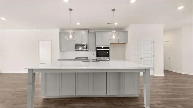a kitchen with kitchen island white cabinets and refrigerator