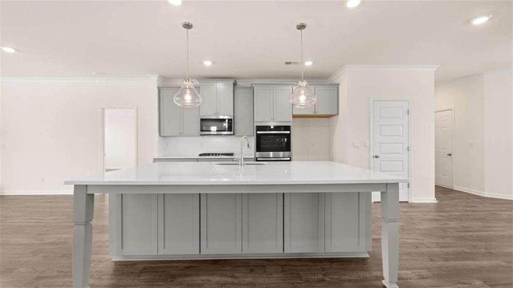 1812 Quaker Street Hampton, GA 30228 - Photo 11 of 53 a kitchen with kitchen island white cabinets and refrigerator