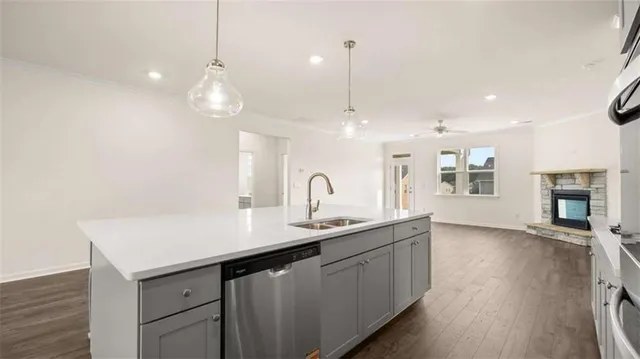 a kitchen with stainless steel appliances granite countertop a stove microwave and sink