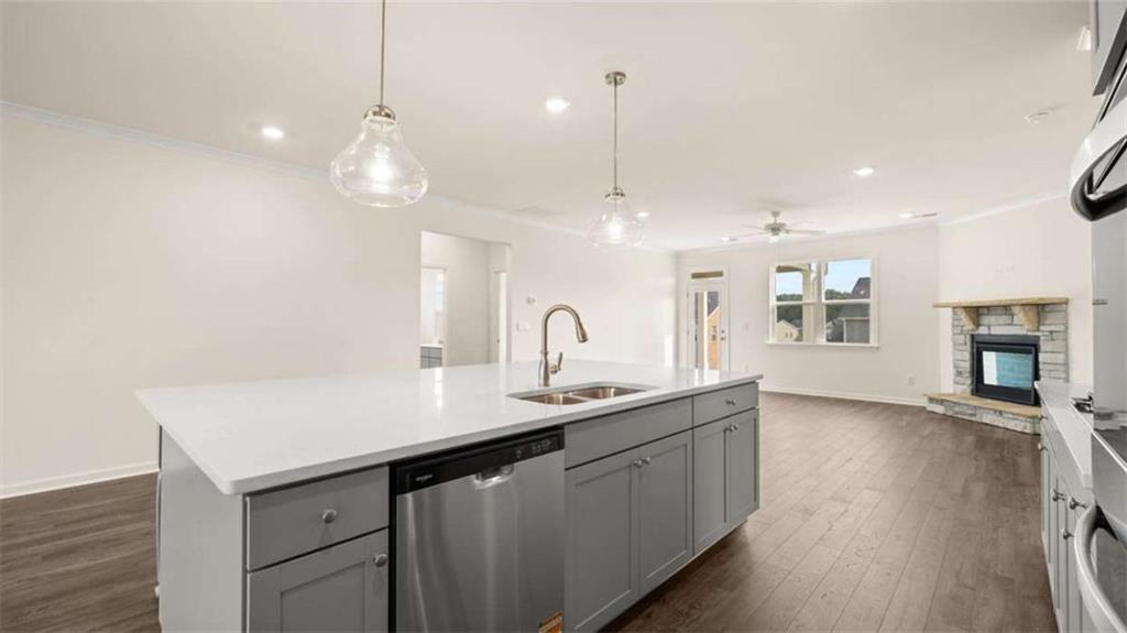 1812 Quaker Street Hampton, GA 30228 - Photo 14 of 53 a kitchen with a sink chandelier and wooden floor