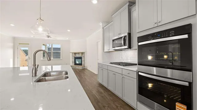 a kitchen with a sink a stove and cabinets