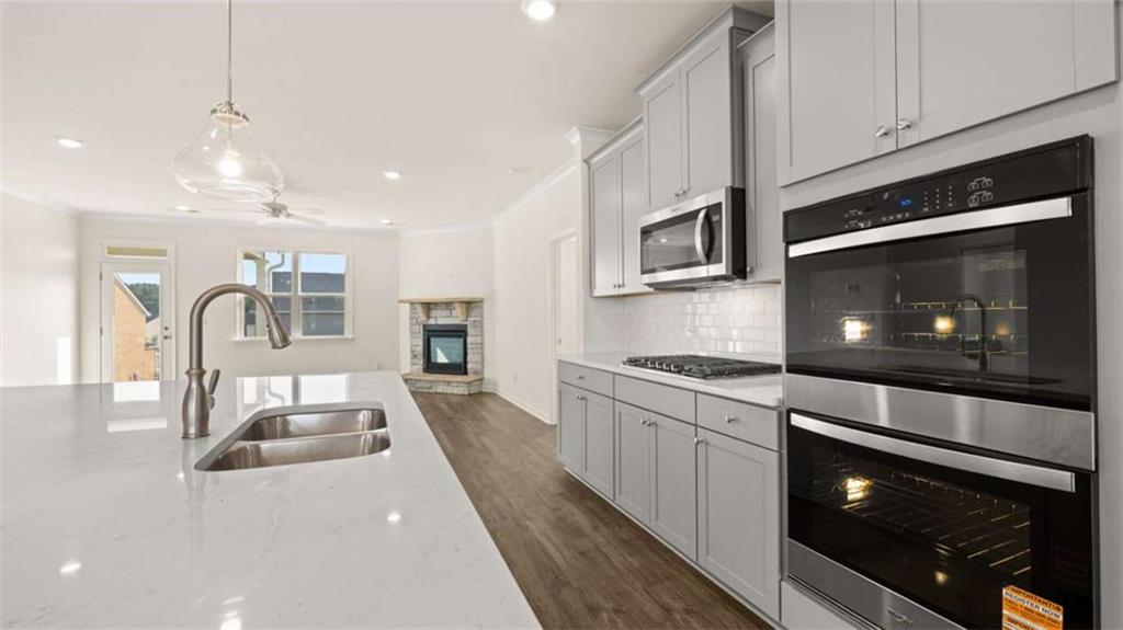 1812 Quaker Street Hampton, GA 30228 - Photo 15 of 53 a kitchen with stainless steel appliances granite countertop a stove microwave and sink
