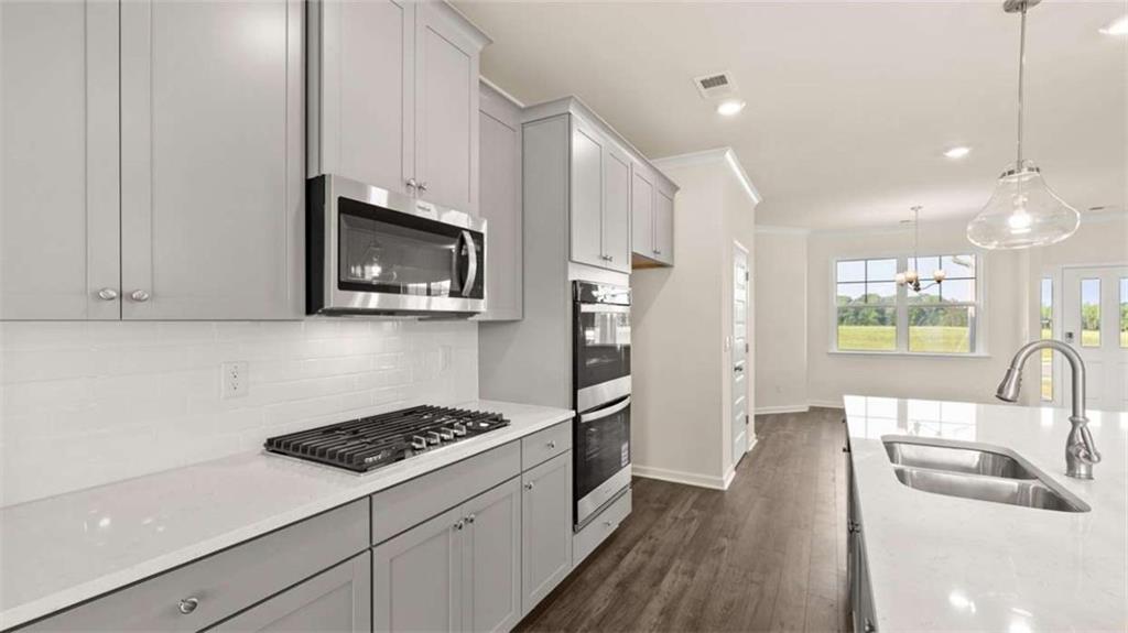 1812 Quaker Street Hampton, GA 30228 - Photo 16 of 53 a kitchen with a sink a stove and cabinets