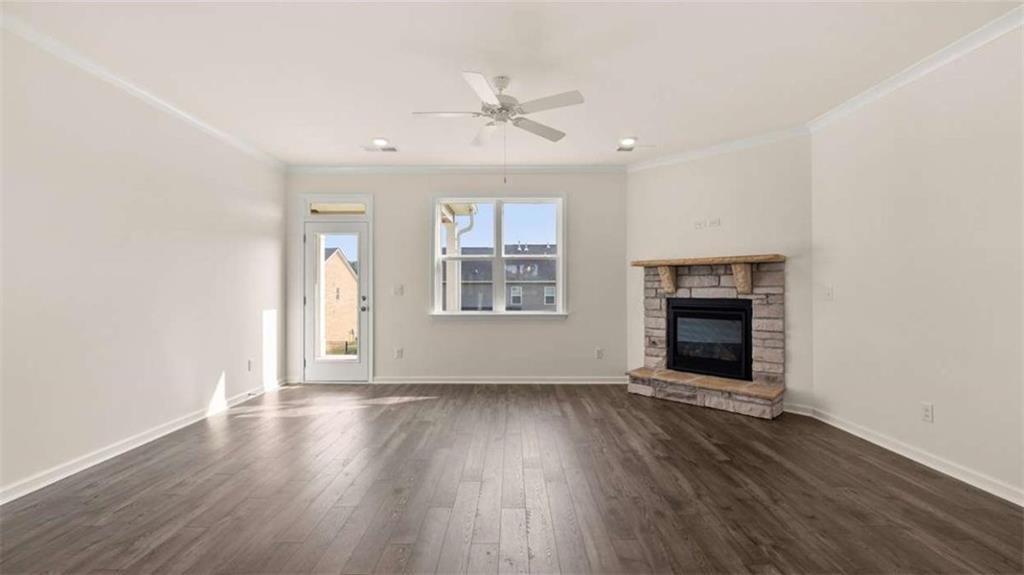1812 Quaker Street Hampton, GA 30228 - Photo 21 of 53 an empty room with wooden floor a ceiling fan and windows