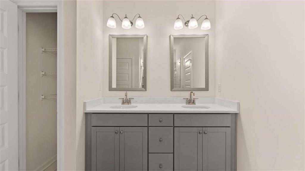 1812 Quaker Street Hampton, GA 30228 - Photo 31 of 53 a bathroom with a double vanity sink and a mirror