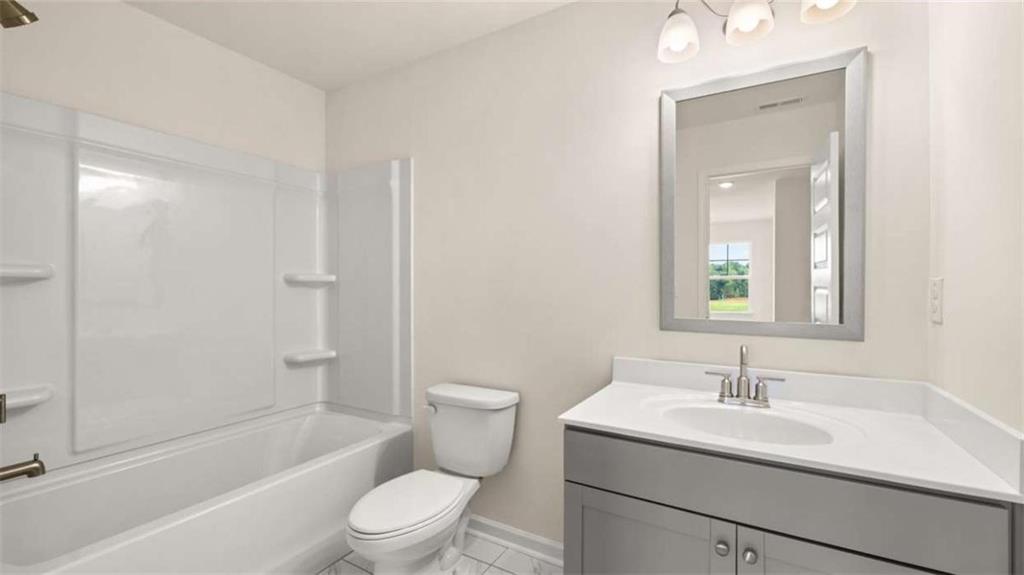 1812 Quaker Street Hampton, GA 30228 - Photo 46 of 53 a bathroom with a sink toilet vanity and shower