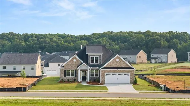 a view of house with garden and tall trees