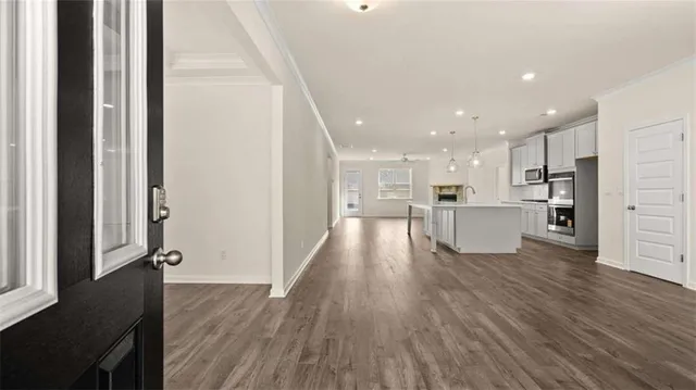 a view of kitchen dining table chairs microwave and cabinets