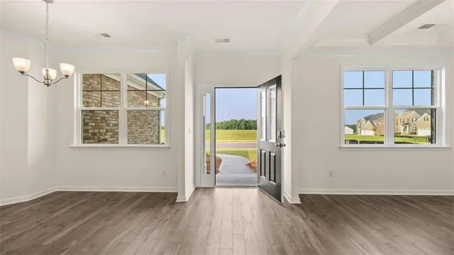 a view of a hallway with wooden floor and a cabinet