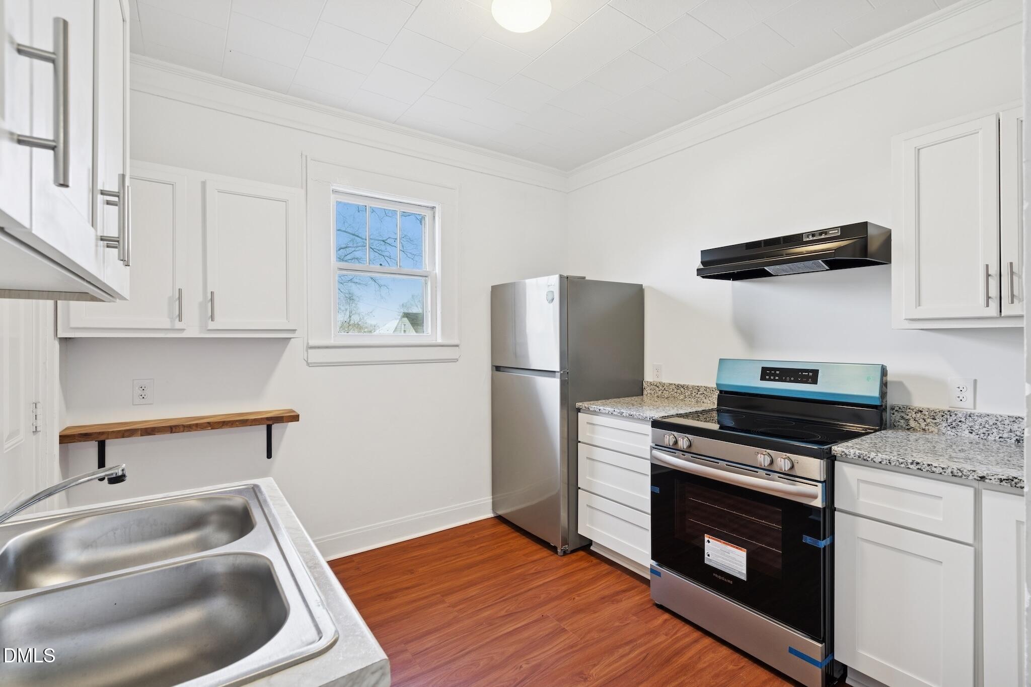 705 North Driver Street Durham, NC 27703 - Photo 17 of 46 a kitchen with stainless steel appliances a stove a sink and a refrigerator