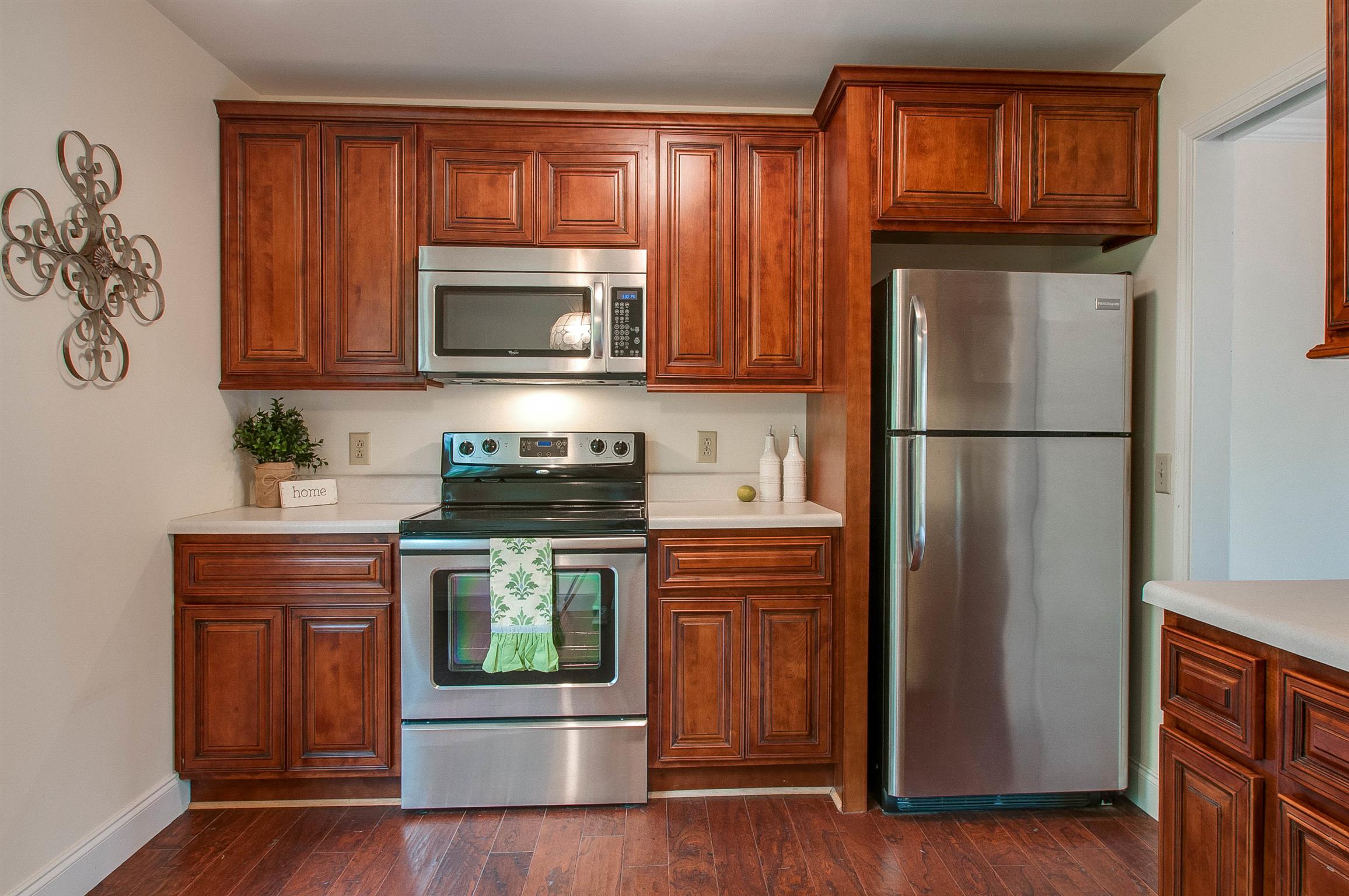 850 General George Patton Road, Unit 850 Nashville, TN 37221 - Photo 11 of 25 a kitchen with granite countertop stainless steel appliances and wooden cabinets