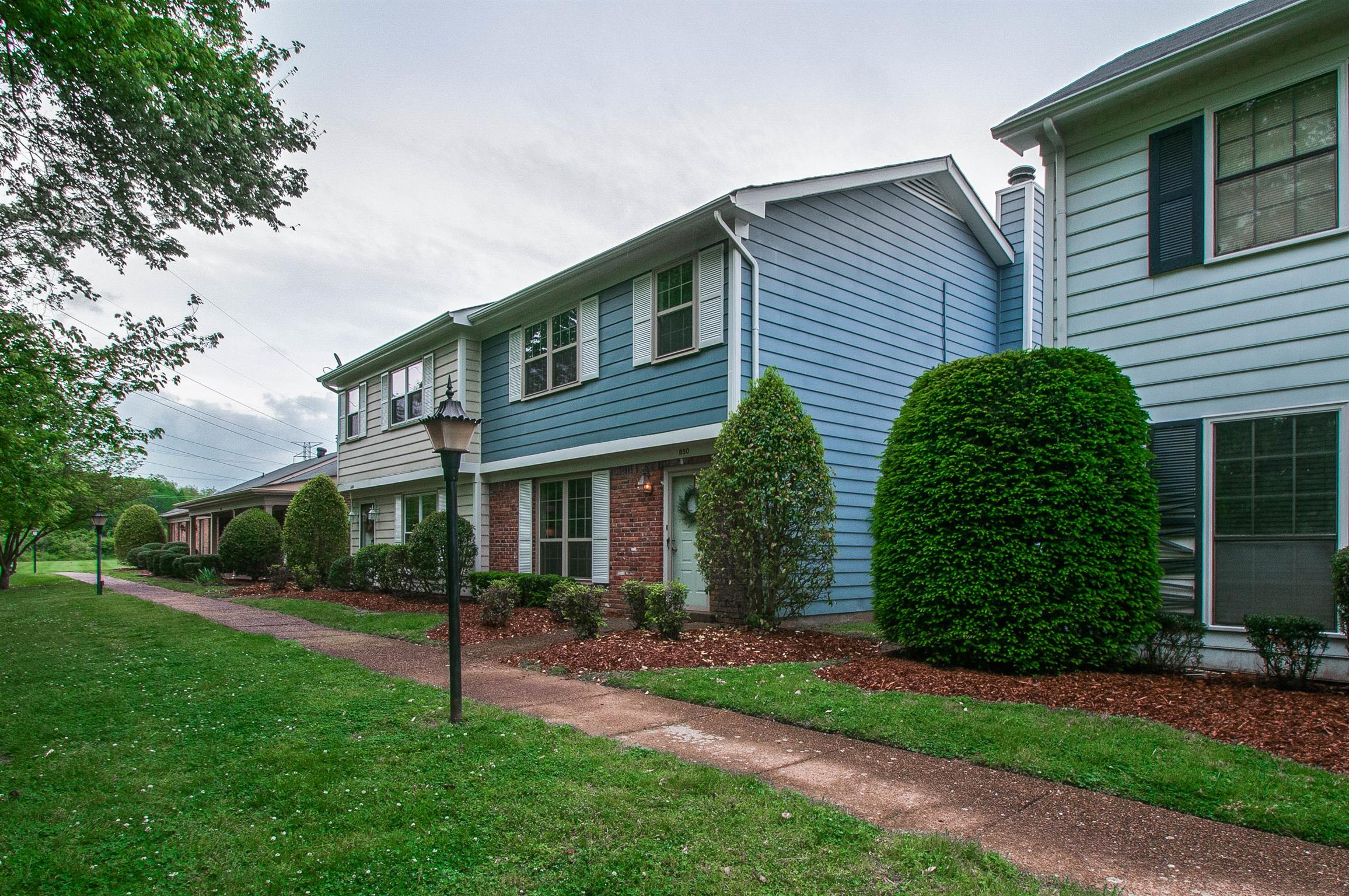 850 General George Patton Road, Unit 850 Nashville, TN 37221 - Photo 2 of 25 a front view of a house with a garden