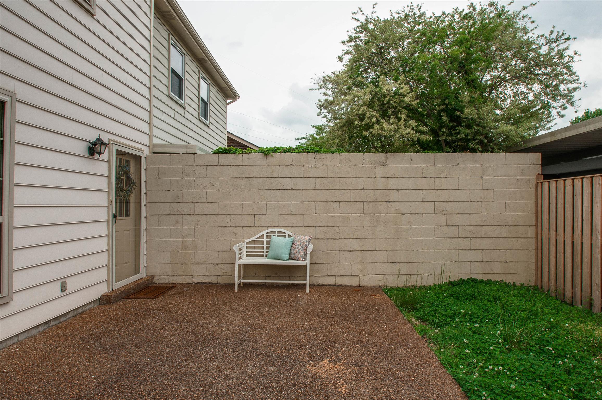850 General George Patton Road, Unit 850 Nashville, TN 37221 - Photo 23 of 25 a view of a patio with table and chairs with wooden fence and plants