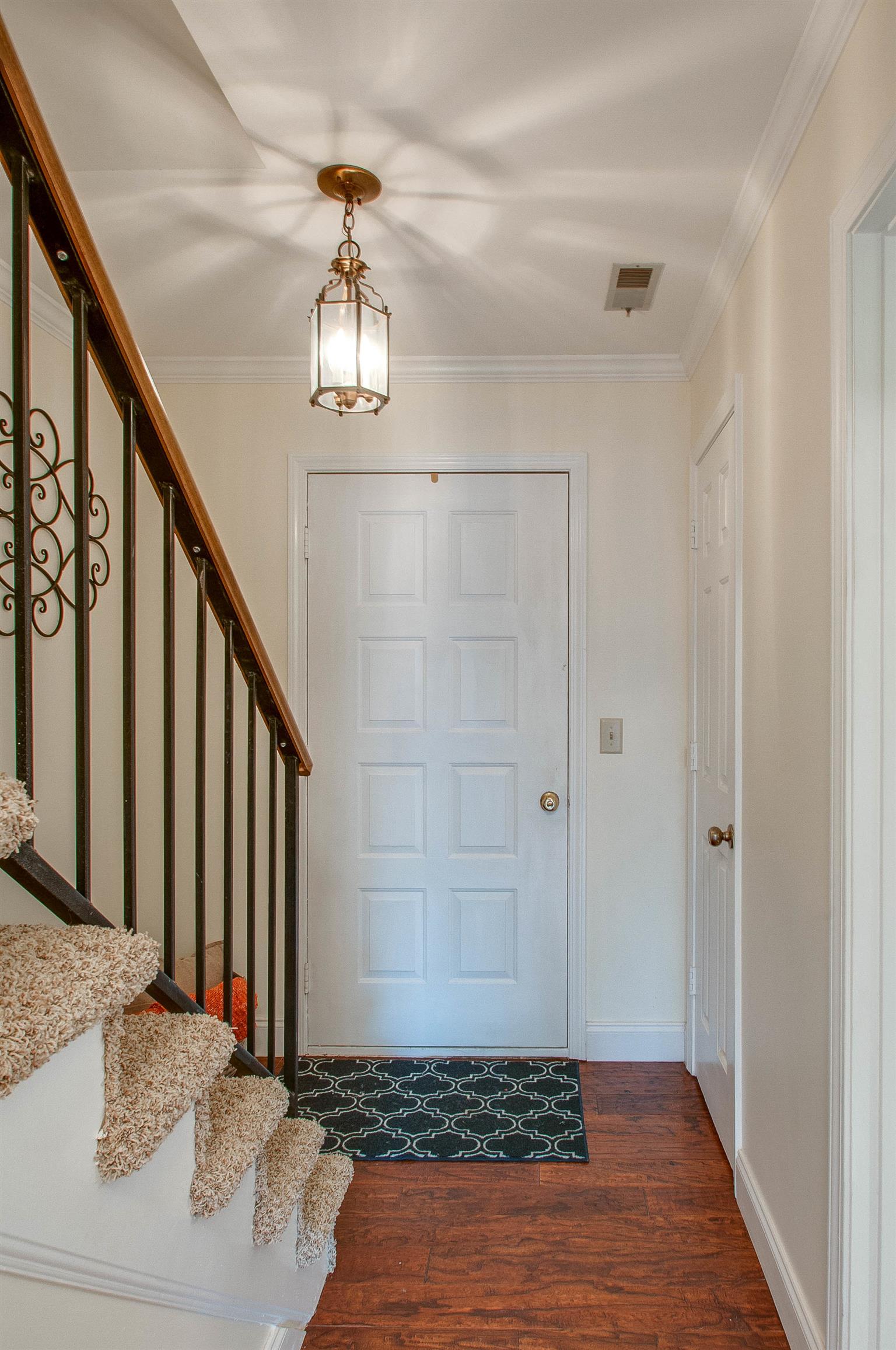 850 General George Patton Road, Unit 850 Nashville, TN 37221 - Photo 4 of 25 a view of a hallway with wooden floor and staircase