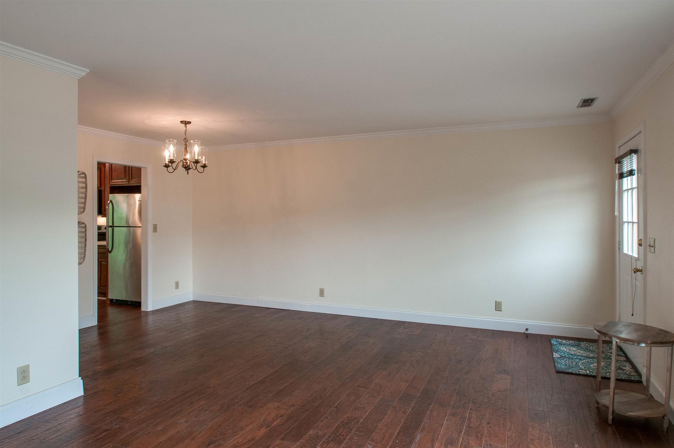 850 General George Patton Road, Unit 850 Nashville, TN 37221 - Photo 7 of 25 an empty room with wooden floor and a window
