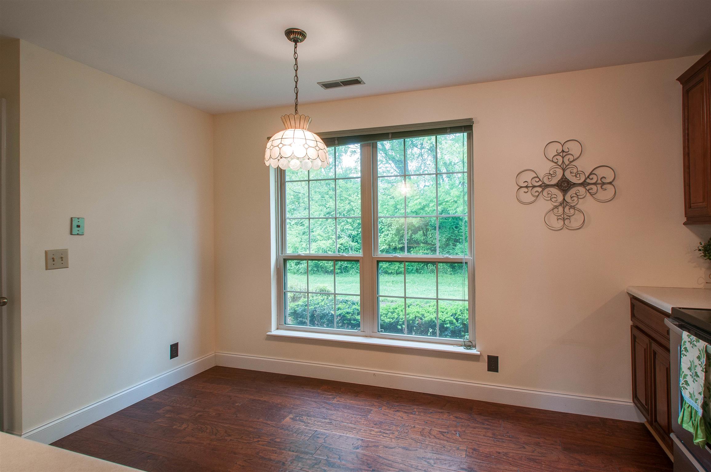 850 General George Patton Road, Unit 850 Nashville, TN 37221 - Photo 9 of 25 a view of an empty room with a window and wooden floor